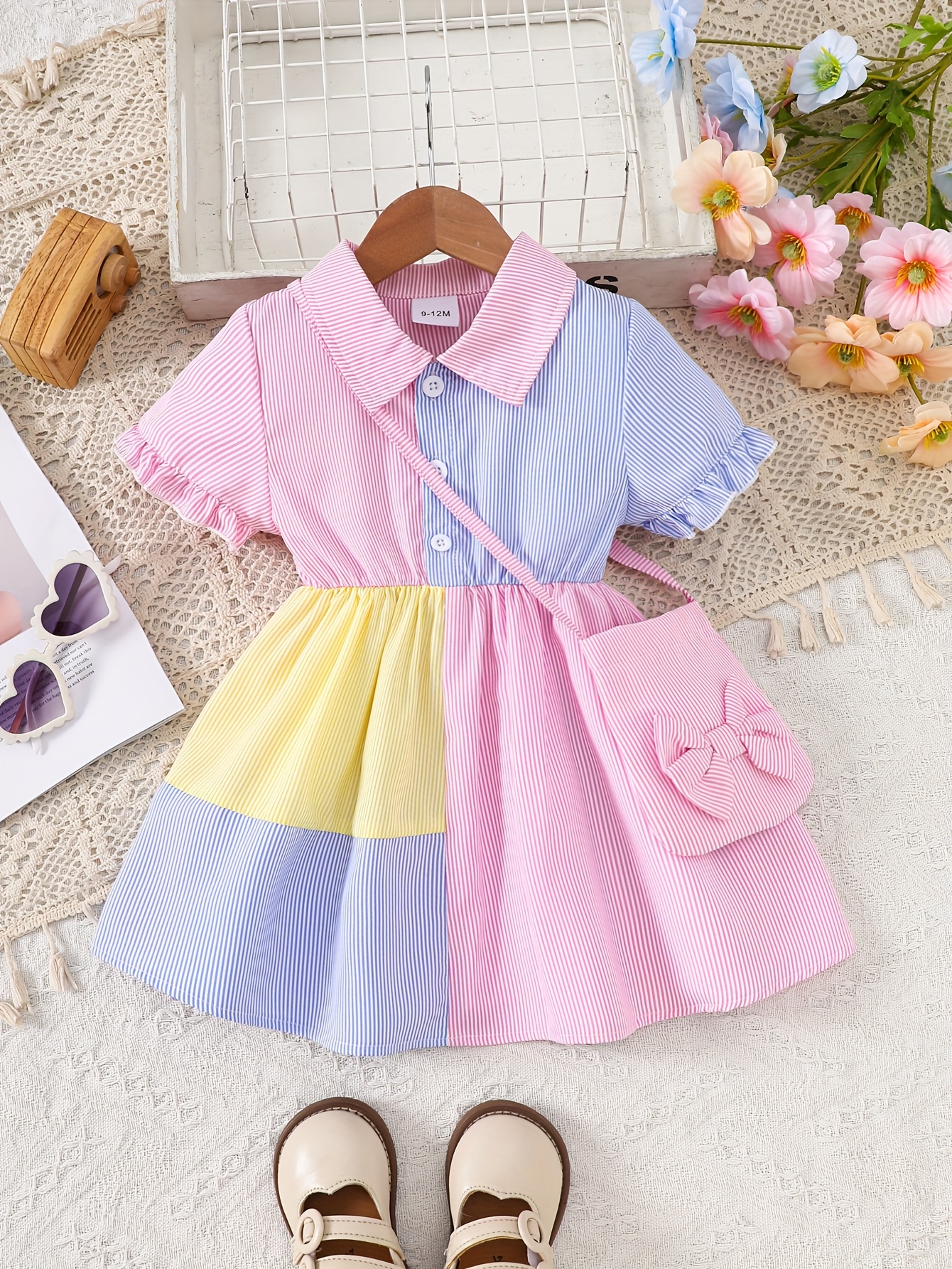 A Cute And Loose Summer Dress for Baby Girls Featuring Colorful Stripes And a Contrasting Design, Paired with a Bow Bag, Perfect for Vacation Relaxation And Everyday Wear