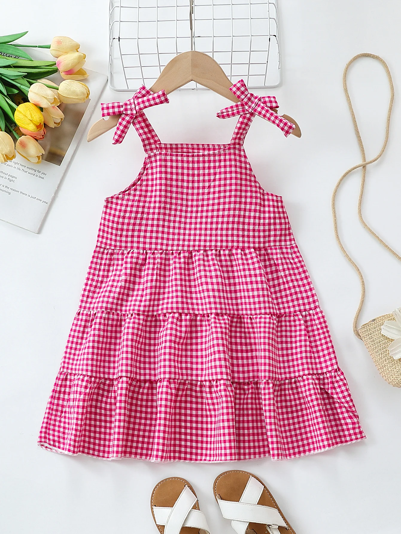 Robe d'été pour bébé fille rose à carreaux vichy, bretelles à nœud, volants superposés, coupe trapèze, idéale pour les fêtes et les occasions spéciales. En polyester.